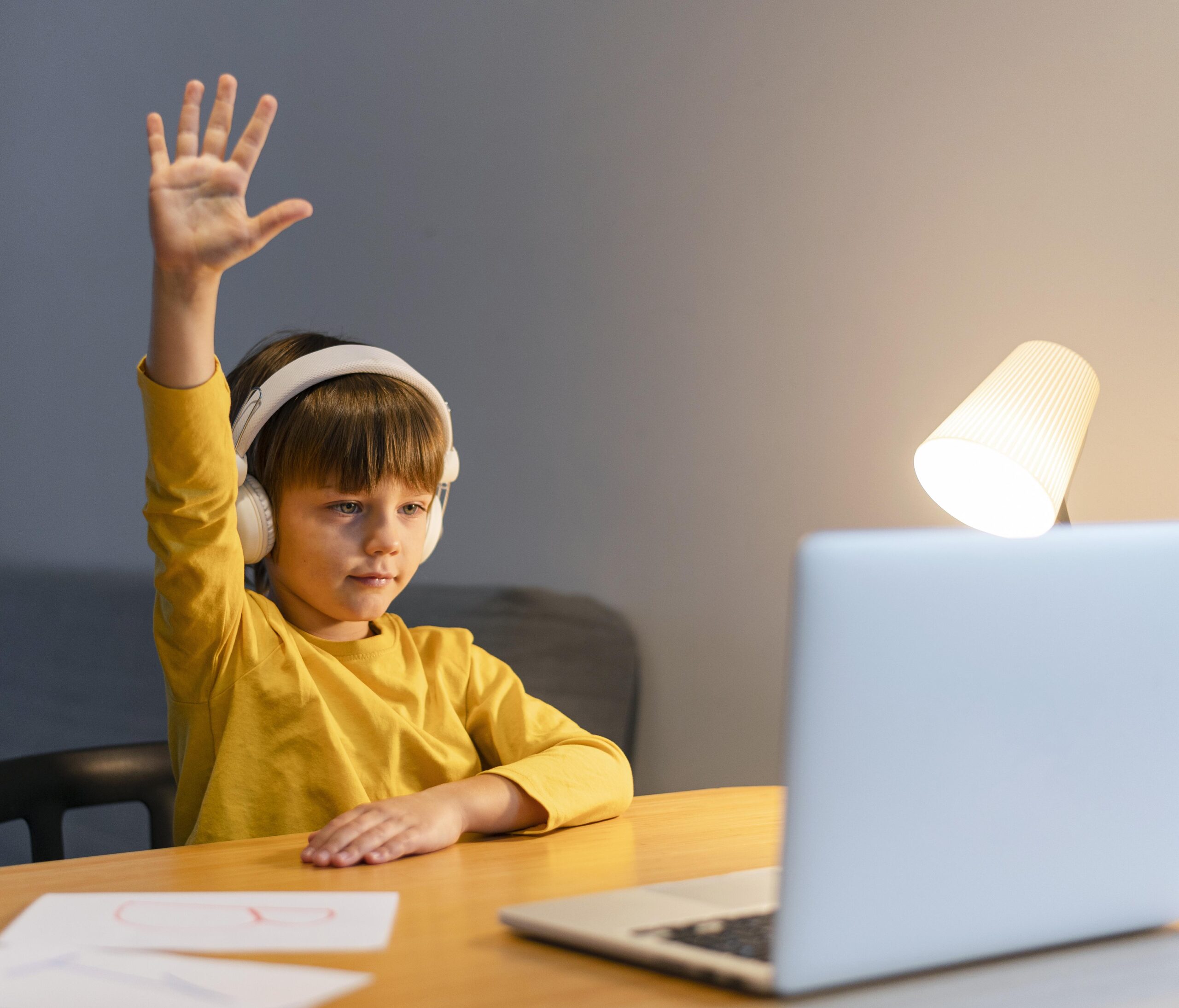http://www.sieraschool.com/wp-content/uploads/2021/12/school-boy-yellow-shirt-taking-virtual-classes-raising-hand-scaled.jpg